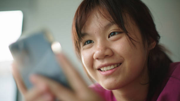 istock Teenager using smartphone in bedroom. 2165360360