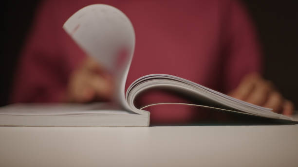 istock Teenager reading a book at night. 2165360441