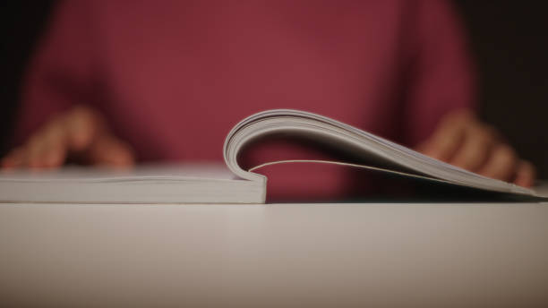 Young asian girl student reading a book at home during night.