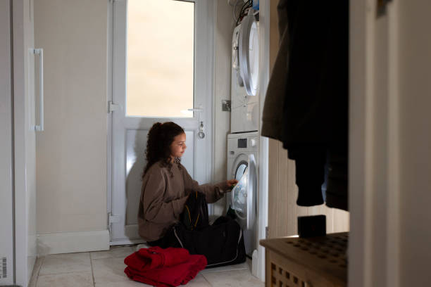 istock Girl Handling Laundry Duties 2165363768