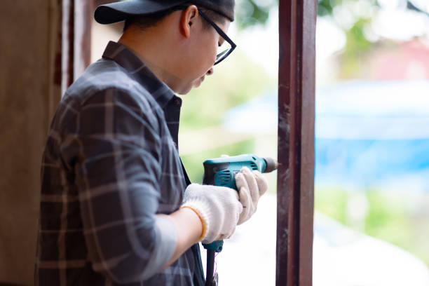 istock Asian worker is using an electric drill for installing wooden panes on the window at under construction home. 2165370530