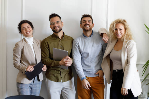 istock Portrait Of Smiling Businesspeople Standing In Front 2165373230
