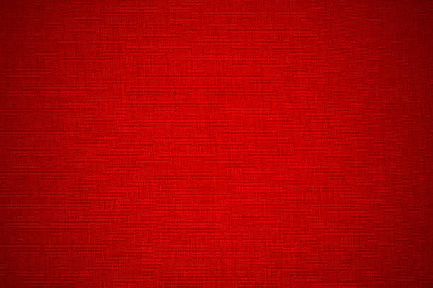 top view of orange burlap fabric showing coarse woven fibers. Detailed textile surface suitable for material backgrounds and design references.
