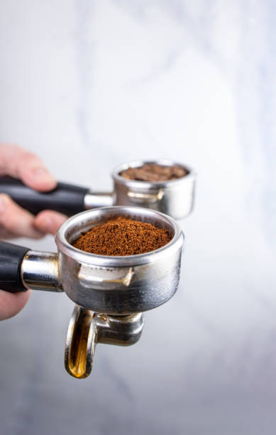 istock Coffee grinder and coffee beans on white marble background. 2165374432