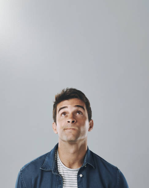 istock Thinking, studio and man with confusion, doubt and remember of ideas in mockup, mind and brainstorming. White background, entrepreneur and person with questions, inspiration and space 2165375164