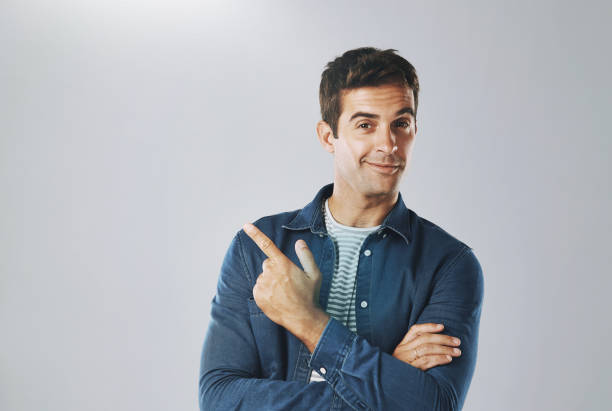 istock Portrait, pointing and man with review, opportunity and model on grey studio background. Face, person and guy with hand gesture, mockup space and promotion with discount deal, information and review 2165375167