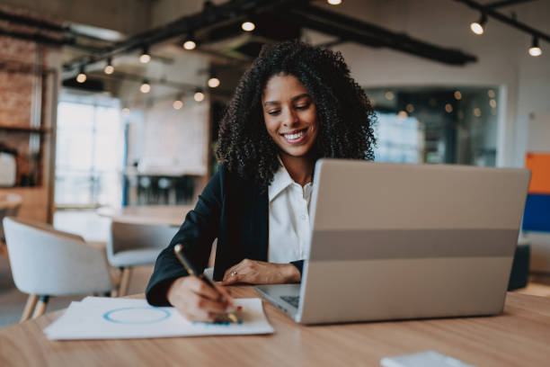 istock Young businesswoman using laptop at desk 2165381108