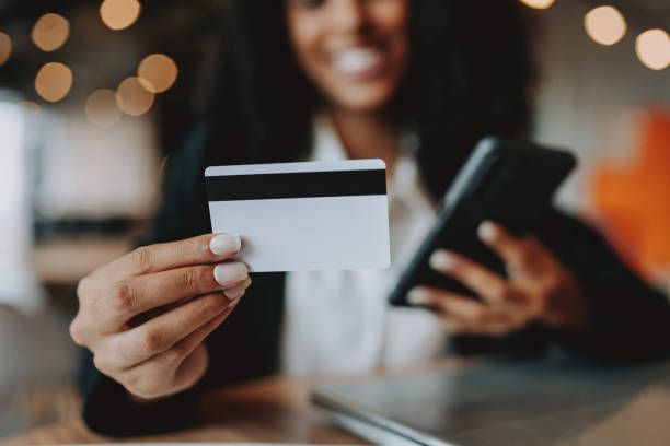 istock Young woman holding credit card 2165381162