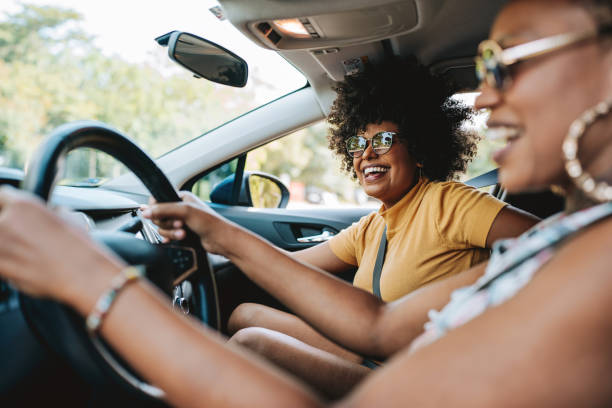 istock Happy friends traveling by car 2165382927