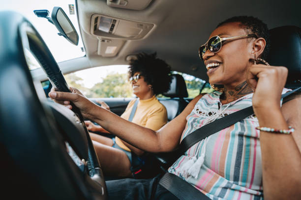 istock Happy friends traveling by car 2165382939