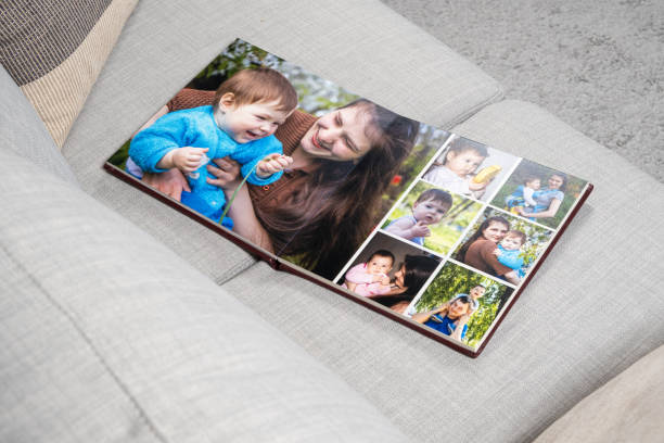 istock Open Family Photo Book on Sofa Top View. 2165383582