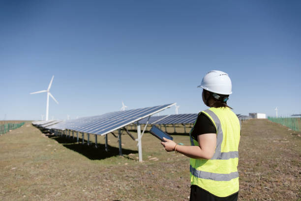 istock female technician working in solar power panels 2165384250