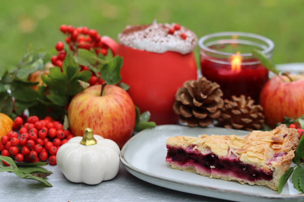 Homemade pie with berries and apples on a background of green grass. Thanksgiving dessert recipe.