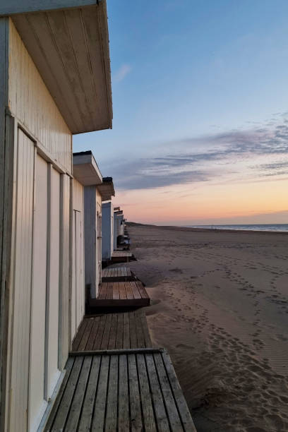 istock Beachfront Cabins at Sunset with Tranquil Ocean View - Ideal for Summer Vacation Poster or Travel Guide Design 2165387387