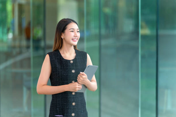 istock Young Woman Holding A Tablet, Looking Away Smiling 2165388957