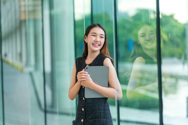 istock Young Woman Holding A Tablet, Looking Away Smiling 2165389756