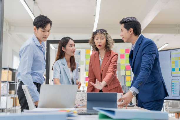 istock Creative Asian professionals brainstorming in a modern office. Business team collaborating on innovative ideas and strategies in a contemporary workspace, emphasizing teamwork and dynamic thinking 2165389839