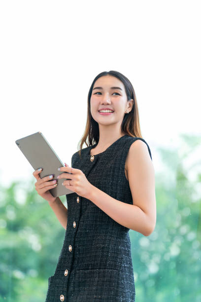 istock Young Businesswoman Using A Tablet, Looking Away Smiling 2165389913