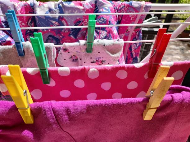 istock Drying children clothes with clothespins 2165391661