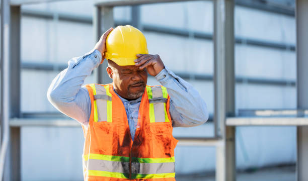 istock African-American construction worker putting on hardhat 2165396422