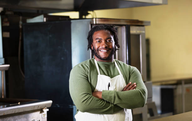 istock Man wearing on apron in commercial kitchen 2165396509