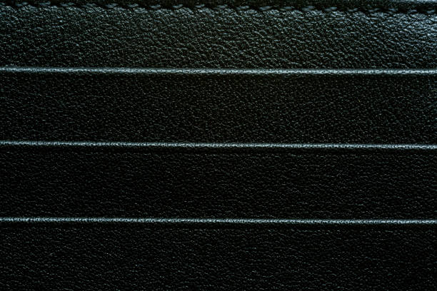 istock Black leather texture macro,Black skin textile. Texture of leather. Surface with different black gradient. Lizzard or fish. Wallet, briefcase or purse from fibere material 2165396645