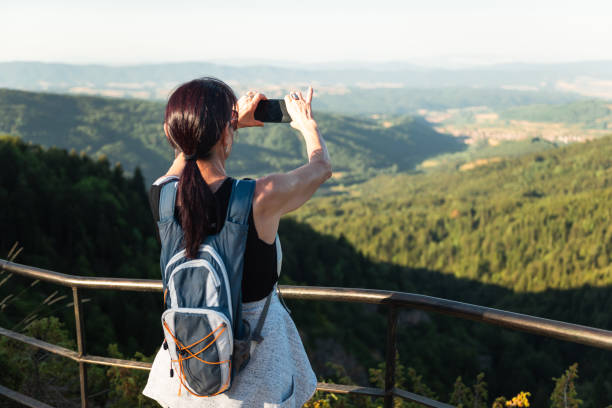 istock Woman enjoys scenic view from a viewpoint 2165397752