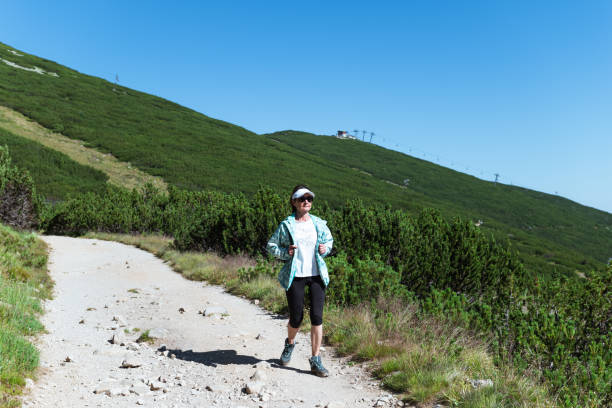 istock Woman hiking in mountains 2165397759