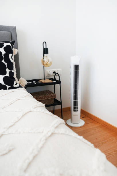 istock White tower fan next to pillows in a modern interior 2165398452