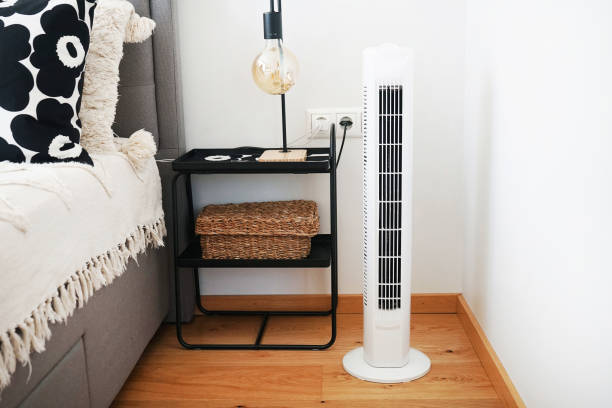 istock White tower fan next to pillows in a modern interior 2165398464
