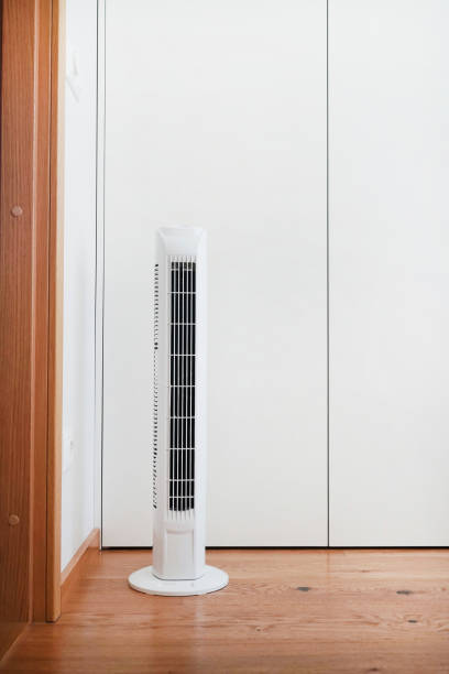 istock White tower fan next to pillows in a modern interior 2165398576