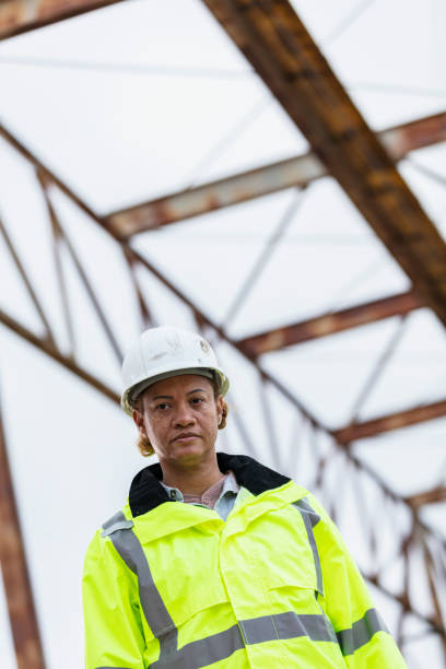 istock Multiracial woman worker standing under gantry crane 2165398615