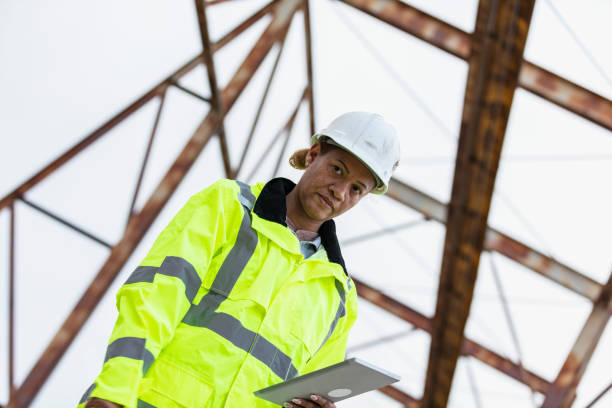 istock Multiracial woman worker standing under gantry crane 2165398623