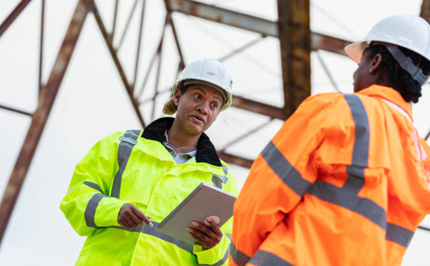 istock Multiracial women working, standing under gantry crane 2165398633