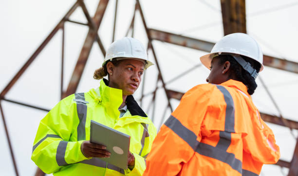 istock Multiracial women working, standing under gantry crane 2165398638