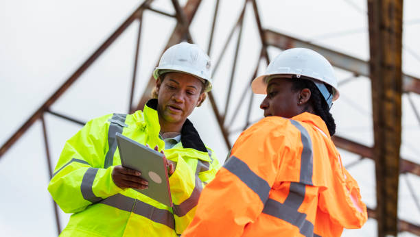 istock Multiracial women working, standing under gantry crane 2165398642