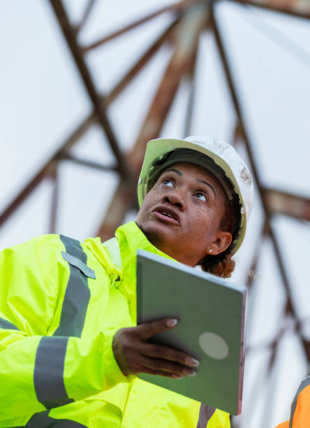 istock Multiracial woman worker standing under gantry crane 2165398649