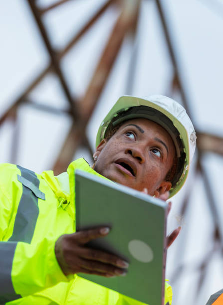 istock Multiracial woman worker standing under gantry crane 2165398656