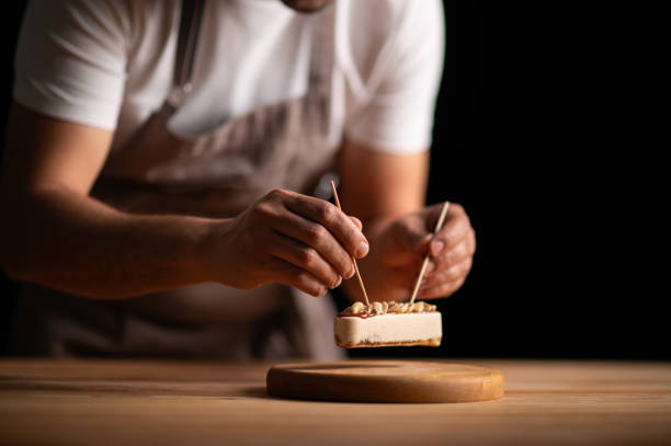 istock A male pastry chef holding a peanut cake with sticks 2165398784