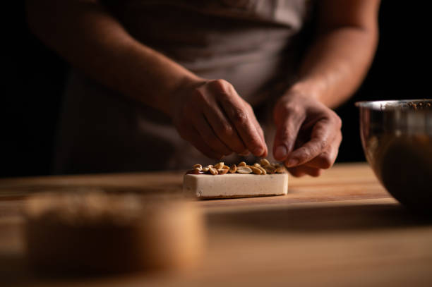 istock A male pastry chef making a cake with peanuts 2165398797