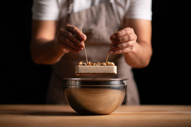 istock A male pastry chef holding a peanut cake with sticks 2165398825