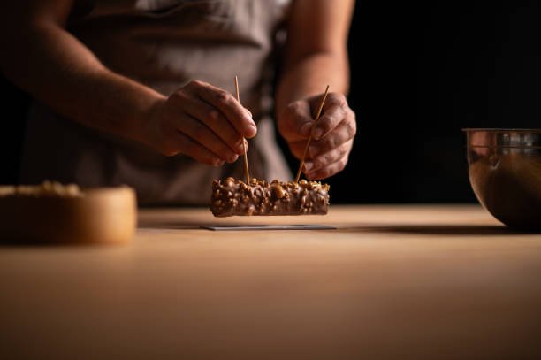 istock A male pastry chef holding a peanut cake with sticks 2165398885