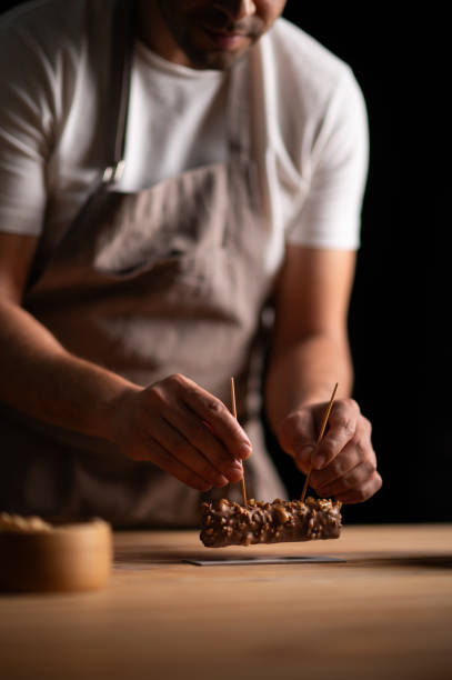 istock A male pastry chef holding a peanut cake with sticks 2165398906