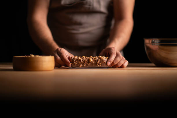 istock A male pastry chef holding a peanut cake 2165398934