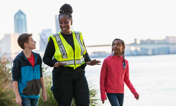 istock Policewoman walking, talking with children in community 2165398944