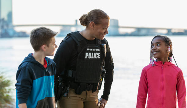 istock Policewoman walking, talking with children in community 2165398946
