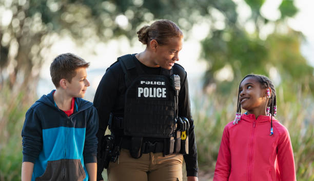istock Policewoman walking, talking with children in community 2165398950