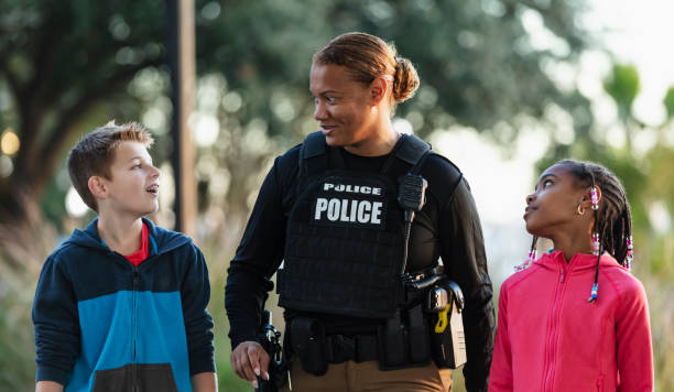 istock Policewoman walking, talking with children in community 2165398951