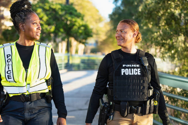 istock Two policewomen patrolling a city park on foot 2165398982