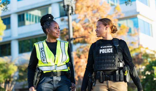 istock Two policewomen patrolling a city park on foot 2165398983